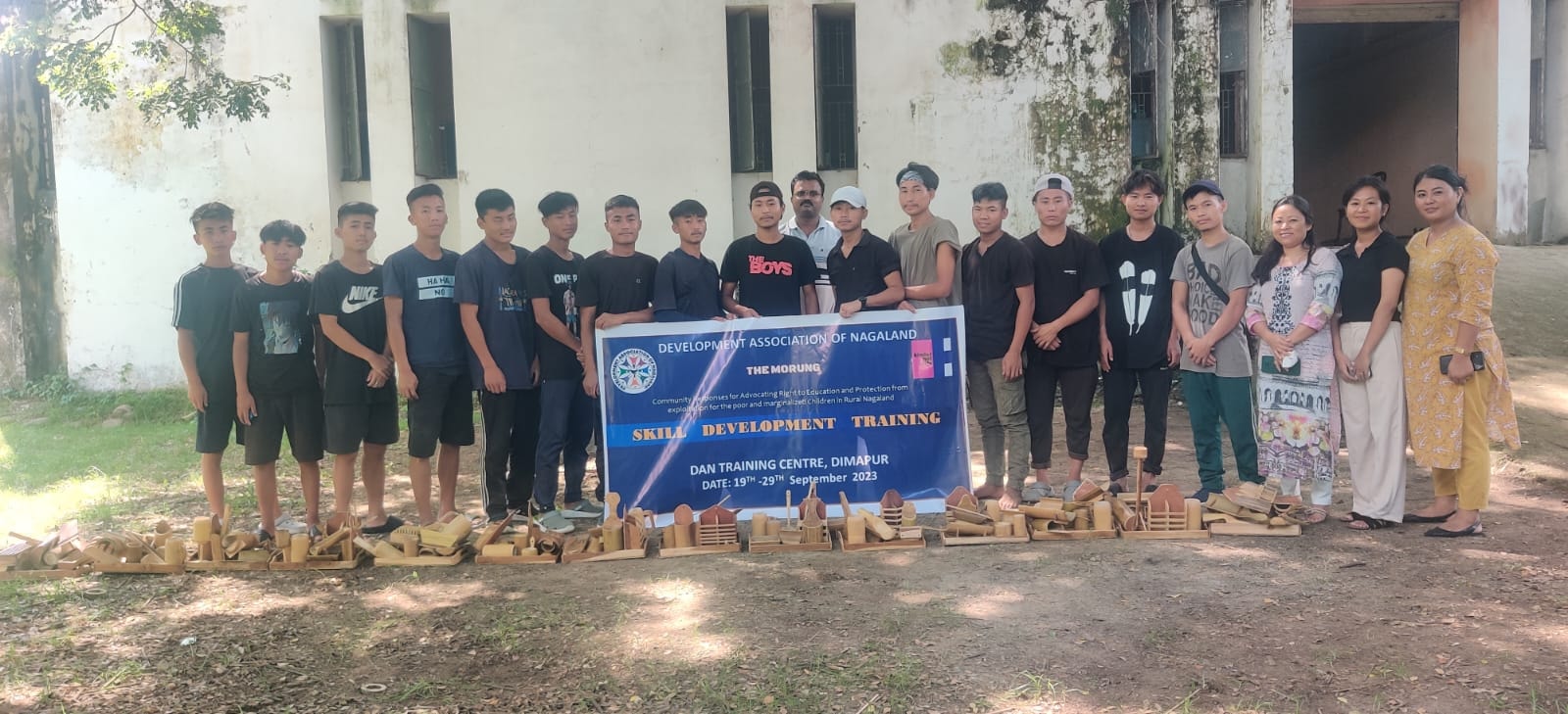 Trainees pose for group photo with project staff after bamboo craft training at DAN